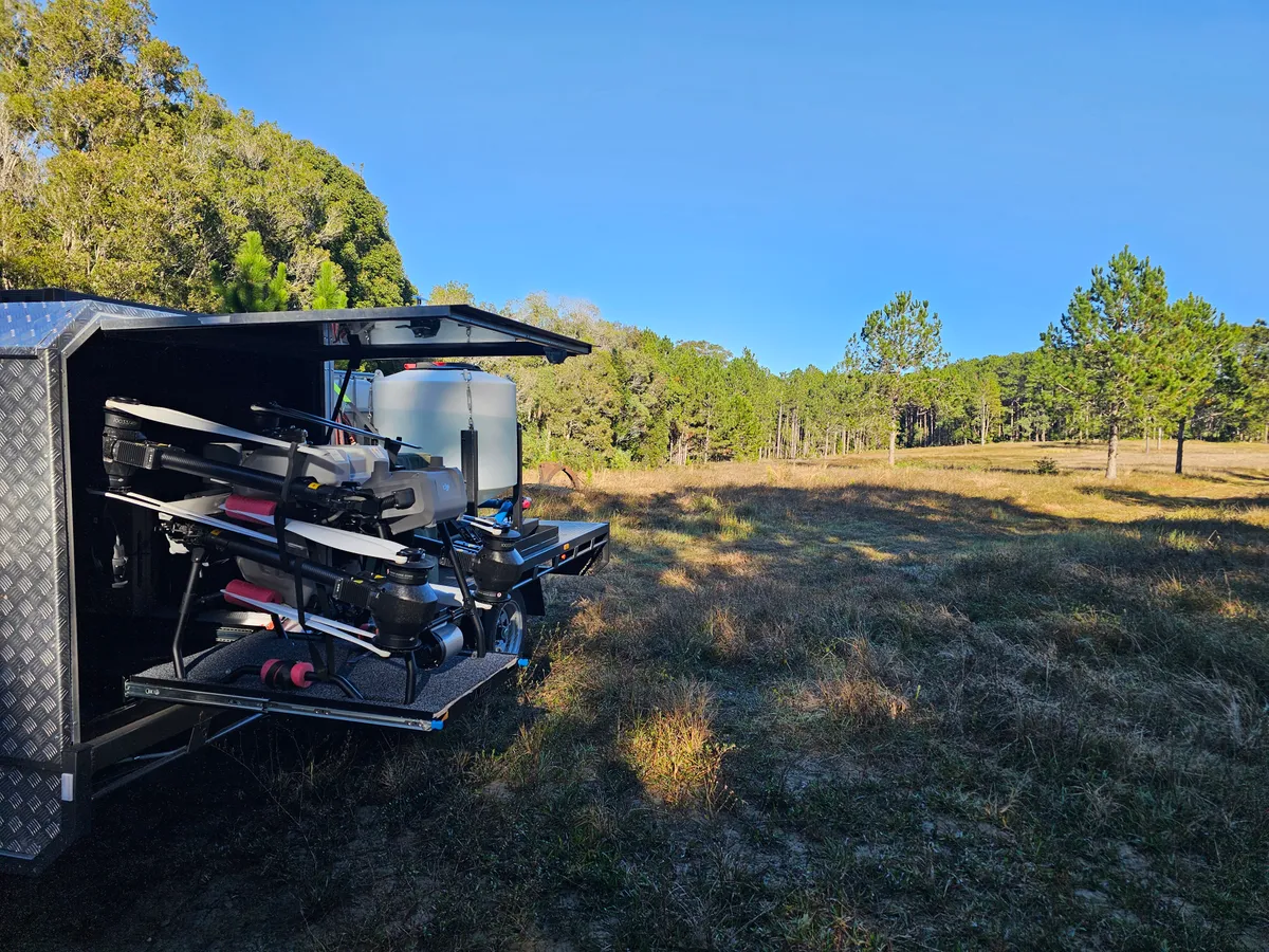 The Country AG Drones mobile rig on site, spray drones and mixing tank loaded on the ute canopy
