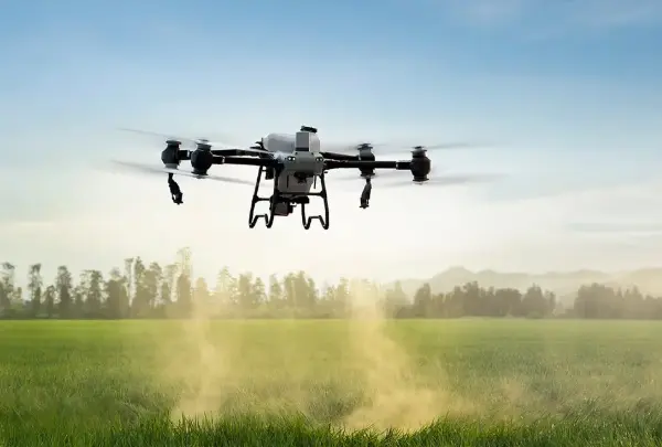 Drone performing aerial spraying over agricultural land